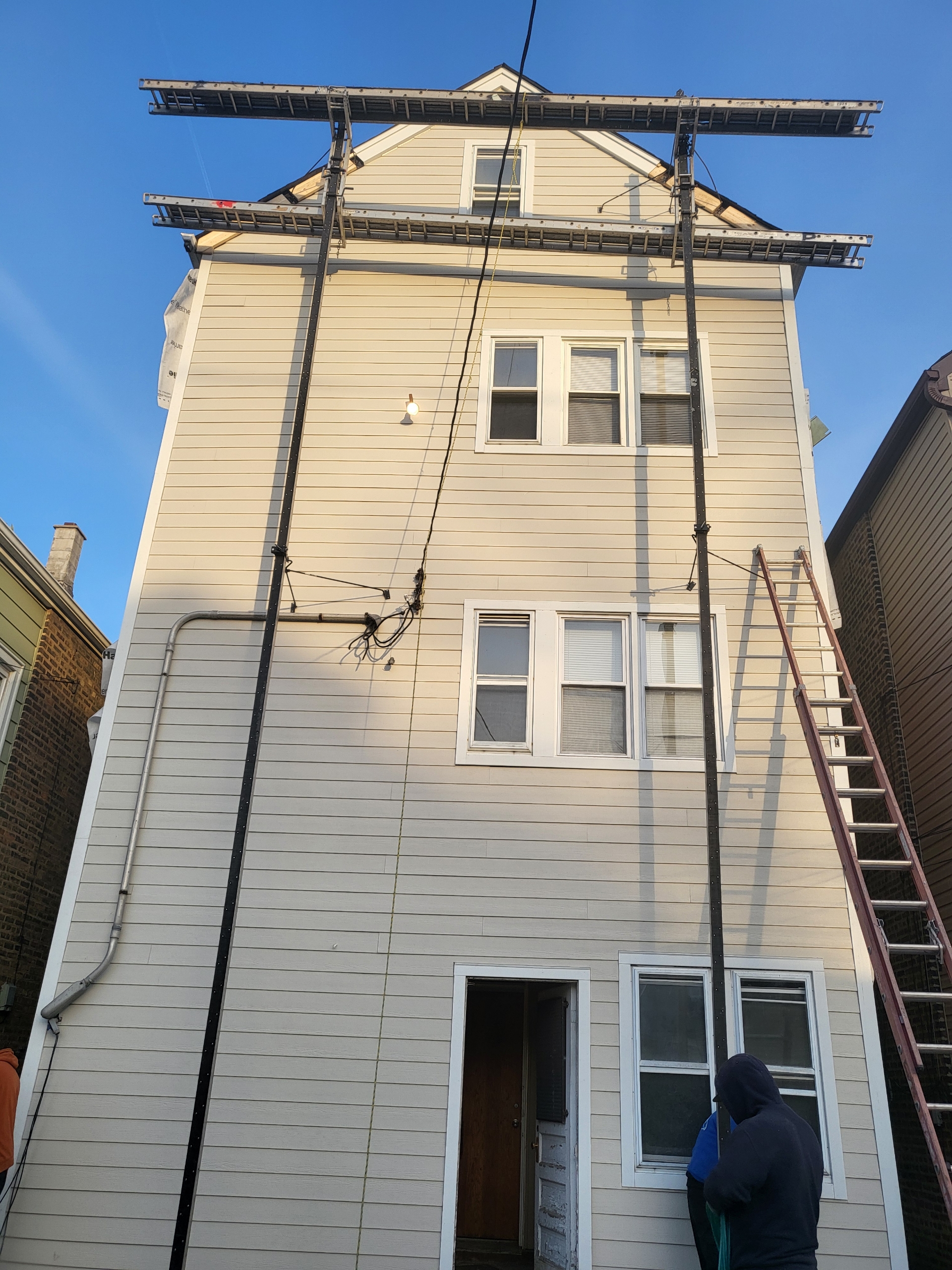 Three-storey frame house, lap siding