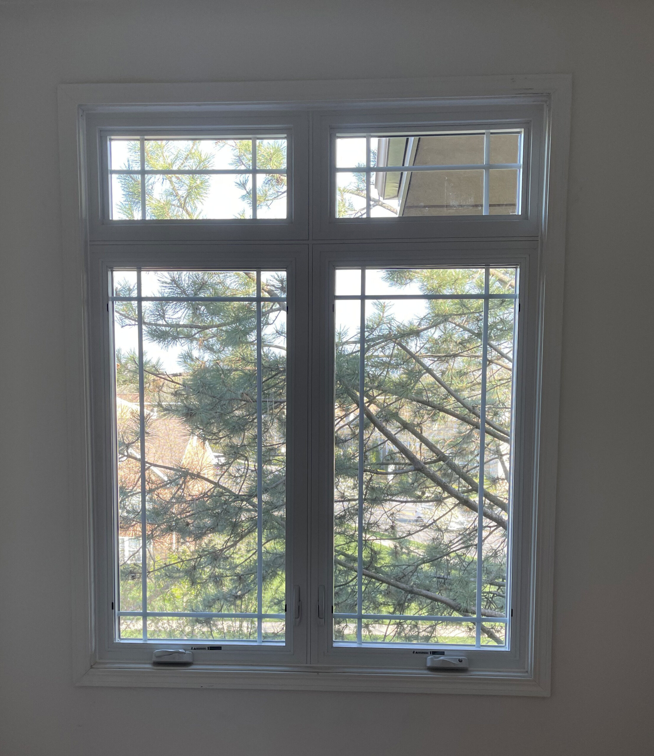 Pella Impervia fiberglass casement windows with transom and grid
