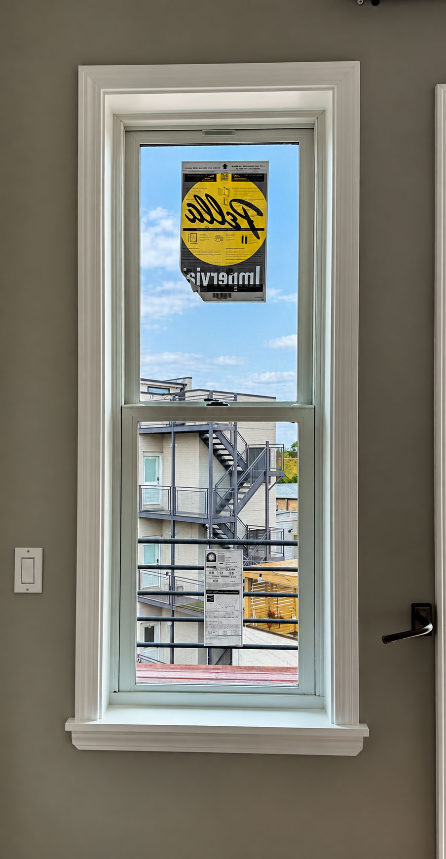 Pella Impervia fiberglass double-hung window, urban installation